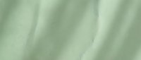 Soft sage green fabric with gentle folds and smooth texture creating elegant drapery waves for luxury interior design and fashion backgrounds.