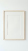Empty wooden picture frame with white mat hanging on neutral wall ready for artwork display and home decor projects.