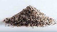 Pile of mixed black and pink salt crystals on white background, gourmet seasoning for culinary use in restaurants and home cooking.