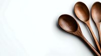 Wooden spoons arranged in fan composition on white background. Minimalist kitchen utensils with natural texture and warm brown tones. Isolated with copy space.