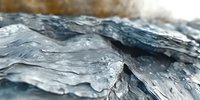 Close up macro view of frozen water surface with crystalline ice formations creating abstract natural pattern with blue and silver tones. Artistic winter background.