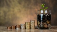 Growing money tree in glass jar with coins and plant sprout symbolizing financial growth, investment success, and wealth building concept for business.