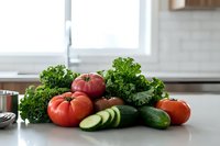 Fresh ripe tomatoes and cucumbers with curly parsley on kitchen counter. Organic vegetables for cooking, healthy eating, meal preparation and recipe development.