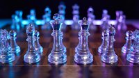 Glass chess pieces on wooden board with dramatic blue and purple lighting creating strategic game atmosphere for business concepts and competition themes.