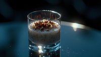 Creamy dessert topped with chocolate shavings in glass against dark background with dramatic lighting and reflective surface, food photography styling.
