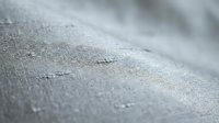 Close-up of gray fabric texture with fine weave pattern and subtle surface details, suitable for textile, material, and design projects.