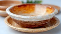 Handcrafted ceramic bowl and plate set with rustic texture and organic shape in earthy tones, featuring natural glaze variations and artisanal finish.