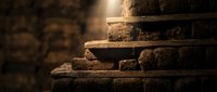 Ancient weathered stone steps with warm golden lighting creating dramatic shadows and textures on historic masonry architecture.