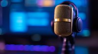 Professional studio microphone with headphones against blurred blue and purple bokeh background, capturing modern podcast recording setup in dramatic lighting.