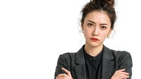 Professional Asian businesswoman in gray suit with crossed arms on white background isolated for corporate design and marketing materials.