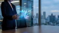 Professional businesswoman analyzing holographic financial data charts and graphs in modern office with city skyline view for corporate presentations.