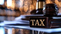 Wooden judge gavel with tax sign on legal documents against blurred background with bokeh lights, representing taxation law and financial justice.