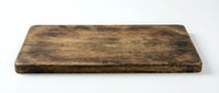 Rustic wooden cutting board with aged, weathered surface and natural grain texture, isolated on white background for kitchen design and culinary projects.