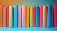 Colorful hardcover books arranged in row against gradient background, spines showing vibrant pastel and bright colors in pink, blue, yellow creating rainbow effect.
