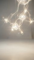 Abstract golden light trails and glowing orbs suspended in ethereal space creating magical luminous patterns for modern interior design and digital art projects.