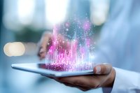 Digital hologram visualization with glowing pink and blue data analytics rising from tablet device in professional hands against blurred background.