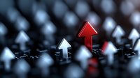 Red arrow standing out among white arrows on dark background, leadership concept showing unique direction and individual choice in business strategy.