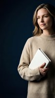 Professional blonde woman in beige sweater holding documents against dark blue background for business and corporate presentations.