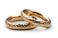 Pair of rose gold wedding bands with hammered diamond pattern texture on white background, luxury jewelry photography for bridal and engagement concepts.