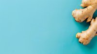Fresh ginger root pieces arranged on turquoise blue background with copy space, minimalist food photography composition for healthy cooking and wellness.