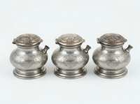 Antique silver decorative vessels with ornamental lids and handles, featuring intricate engraved circular patterns. Set of three matching metal containers for home decor or collectible display.