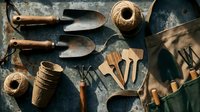 Gardening tools and supplies arranged on rustic surface with trowels, peat pots, twine, and wooden utensils for spring planting and cultivation work.