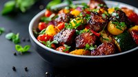 Roasted beets and cherry tomatoes with fresh herbs in black bowl, garnished with microgreens. Colorful vegetarian dish on dark background. Healthy food.