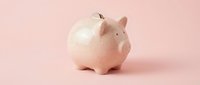 Pink ceramic piggy bank on pastel background for savings and financial planning concepts. Isolated money container for investment education materials.