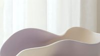 Abstract flowing curves in soft purple and beige tones creating elegant waves against light background for modern interior design and branding.