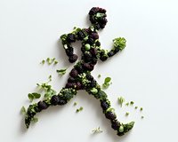 Running figure made from fresh blackberries and green herbs on white background, creative food art composition showing healthy active lifestyle.