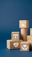 Wooden blocks with healthcare and family protection icons stacked on blue background representing insurance coverage and medical care services.