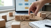 Business strategy planning concept with wooden blocks featuring brain, lightbulb, gears and question mark icons on desk with laptop and notebook.