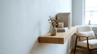 Modern minimalist floating wooden shelf with decorative vase in bright contemporary living room interior with natural light and neutral color palette.