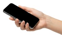 Female hand holding modern smartphone with blank black screen isolated on white background for mobile app mockup and digital technology concepts.