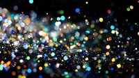Colorful bokeh lights scattered against dark background creating magical sparkle effect, defocused glowing dots in motion for festive atmosphere.