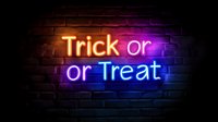 Glowing neon sign reading Trick or Treat on dark brick wall background, Halloween festive decoration in orange, purple and blue colors creating spooky atmosphere.