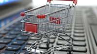 Shopping cart on laptop keyboard symbolizing online retail and e-commerce business concept, digital marketplace for modern consumers.