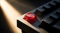 Red panic button on dark surface with dramatic lighting creating urgency and emergency response concept for business and safety applications.