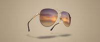 Stylish aviator sunglasses with gradient lenses floating on neutral beige background. Modern eyewear accessory for fashion and sun protection designs.