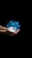 Human hands holding glowing digital globe with technology icons on black background for business and innovation concepts.