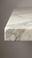 Elegant white marble countertop edge with natural veining patterns showcasing luxury kitchen and bathroom interior design elements for modern homes.
