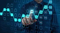 Businessman touching digital interface with glowing hexagonal network icons and data visualization elements on dark technology background.
