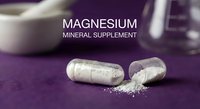 Magnesium mineral supplement capsules spilling white powder on purple surface with mortar and pestle in background for health and wellness.