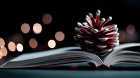 Open book with red pine cone against blurred warm bokeh lights creating magical winter holiday atmosphere, cozy reading concept for seasonal stories and literature.
