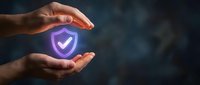 Hands holding glowing purple shield with checkmark symbol, representing data protection, cybersecurity, and trust for business and technology concepts.