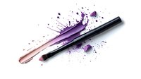 Smashed purple lipstick with black applicator brush and powder splash on white background, cosmetic product destruction artistic composition for beauty industry.