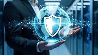 Businessman holding holographic globe with digital shield icon representing global cybersecurity and data protection technology solutions.