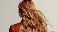 Blonde woman with long wavy hair wearing brown leather jacket, back view against light background. Natural flowing hairstyle shows movement and texture.