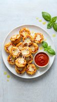 Mini pizza bites with melted cheese and marinara sauce on white plate garnished with fresh basil leaves for appetizer and snack recipes.