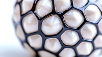 Macro view of white honeycomb geometric pattern with black borders creating abstract modern spherical shape against blurred background. Architectural and design concept.